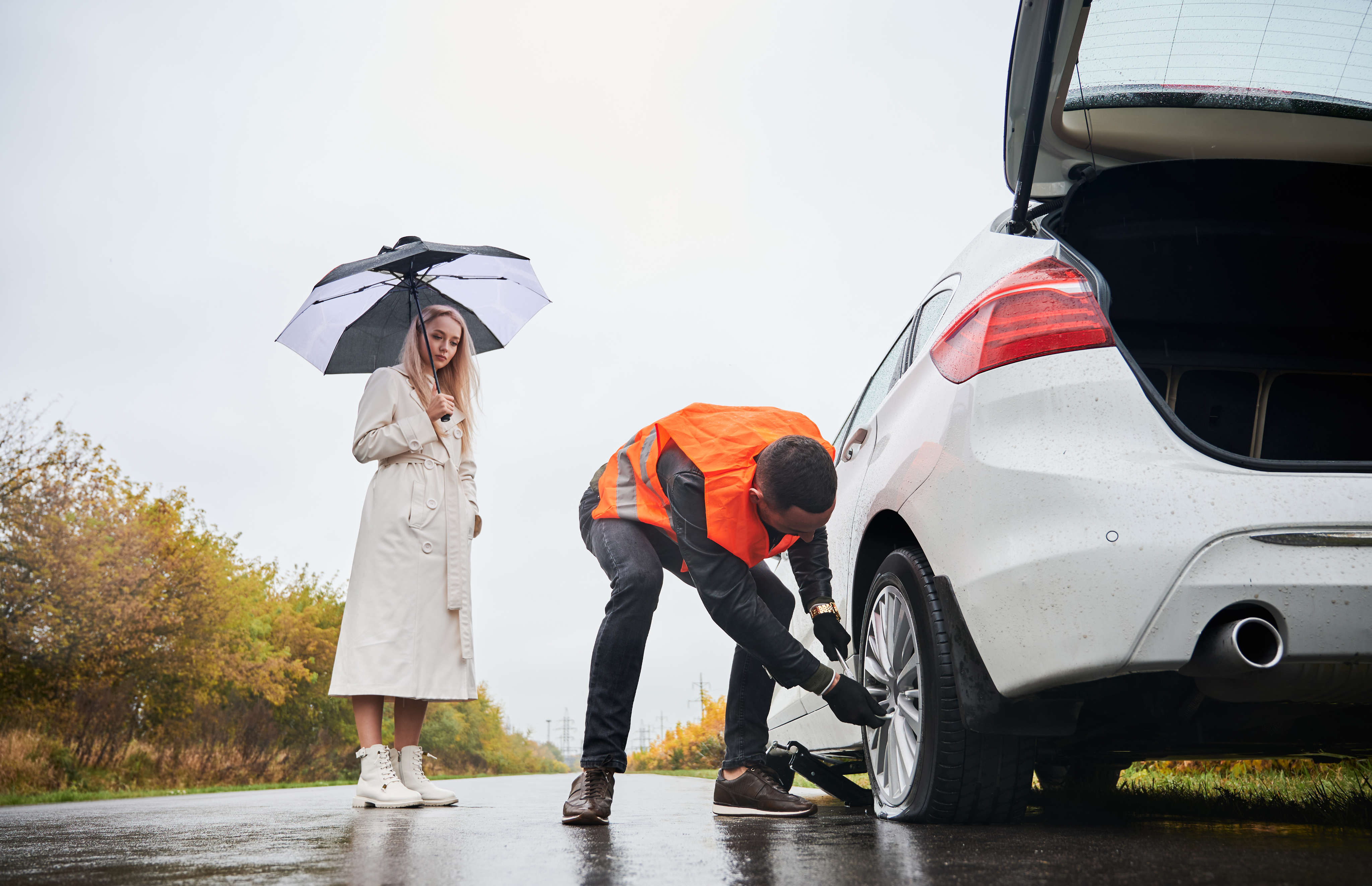 Tire service professional helping customer